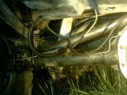 1995 Ford Bronco - Underside view of a vehicle's rear axle assembly, showing suspension and brake lines.
