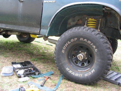 1986 Ford Bronco - Tools are laid out next to a 1986 Ford Bronco as work is done on the wheel well.