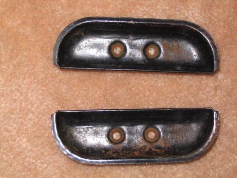 1979 Ford F-250 - Two chrome and black trim pieces, possibly for a vehicle, are shown against a textured background.