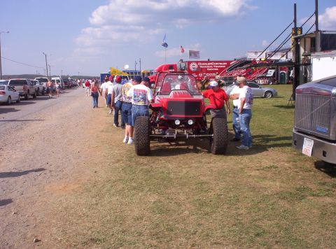 1981 Chevrolet Blazer - A custom red off-road vehicle is displayed with spectators gathered around.