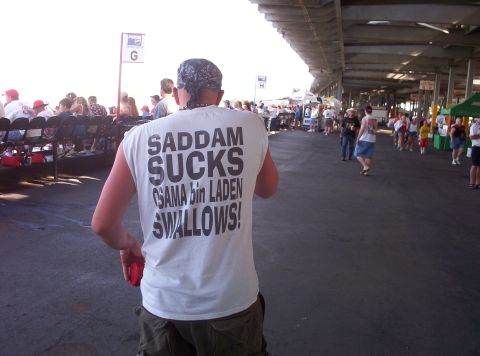 1981 Chevrolet Blazer - Man wearing a t-shirt with political slogans at an outdoor event.
