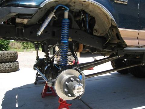 1994 Ford Bronco - The front suspension of a Ford Bronco is shown with upgraded components, including a new shock and brake system.
