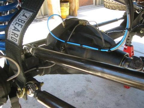 1994 Ford Bronco - Close-up view of a vehicle's rear axle and suspension system, showing various mechanical components.