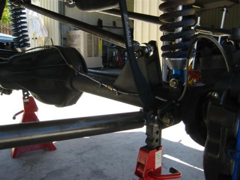 1994 Ford Bronco - Vehicle suspension and differential components are visible, supported by red jack stands.
