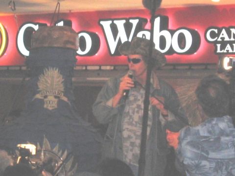 1989 Ford Bronco - A man wearing a cowboy hat and sunglasses sings into a microphone at the Cabo Wabo venue.