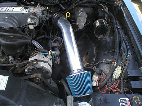 1987 Ford Crown Victoria LTD - Aftermarket cold air intake installed in an engine bay, with Supermotors.net branding visible.