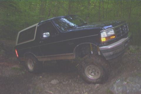 1995 Ford Bronco - 1995 Ford Bronco navigating an off-road trail.
