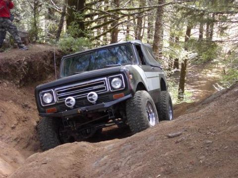 1980 Ford Bronco - This off-road vehicle navigates a steep dirt trail through a wooded area.