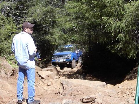 1980 Ford Bronco - 1980 Ford Bronco tackling a challenging rocky trail, demonstrating its off-road capability.