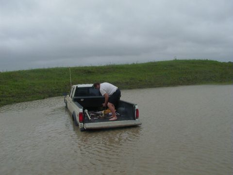 1991 Ford Bronco - Thats me hookin the tow straps and stuff up on his truck the next morning after it rained really hard, so the water in the tank rose about…