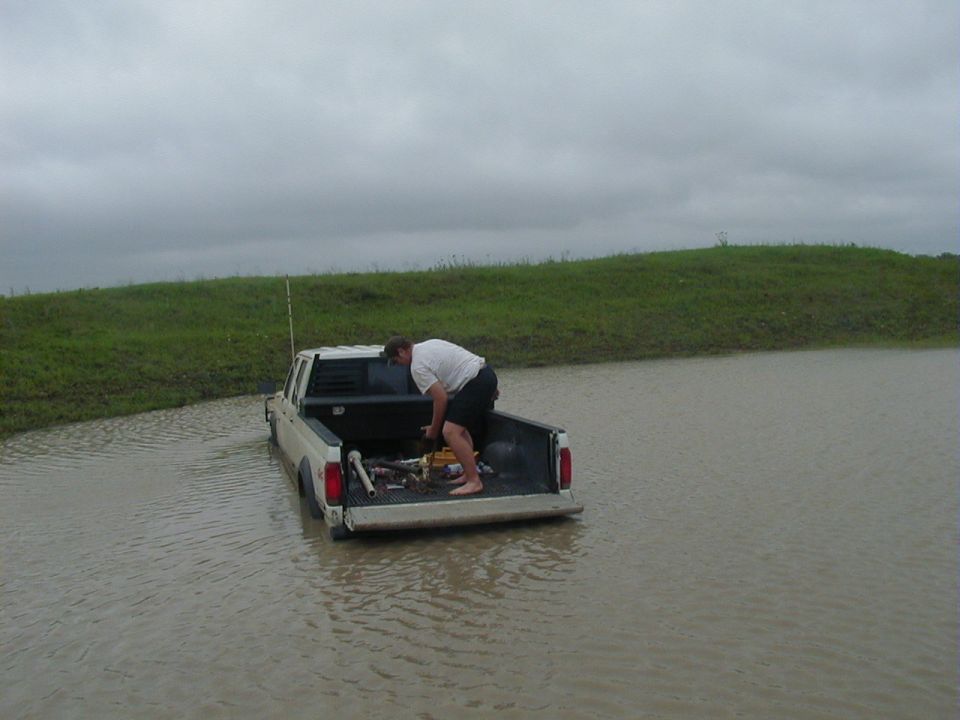 Thats me hookin the tow straps and stuff up on his truck the next morning after it rained really hard, so the water in the tank rose about 6-8 inches, and it was really really cold like 45-50 degrees and windy