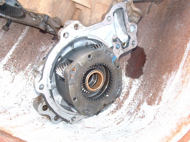Close-up of an open differential housing showing internal gears and bearings