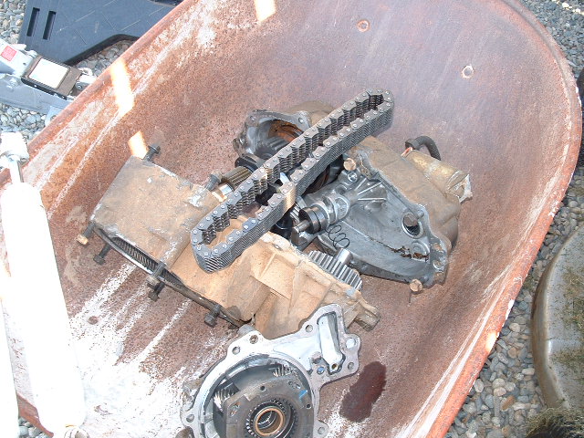 Transfer case components and chain in a rusty wheelbarrow