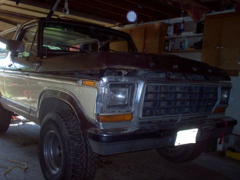 1979 Ford Bronco - Front view of a 1979 Ford Bronco, hood is open, showing the grille and headlights.