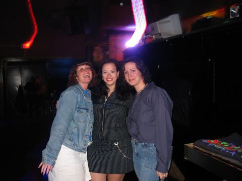 1989 Ford Bronco - Three women smile for the camera while posing in a dimly lit nightclub environment.