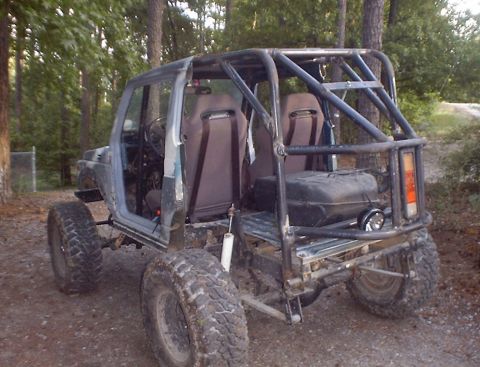 1989 Ford Bronco - This heavily modified Suzuki Samurai features a custom roll cage and off-road tires, suggesting it's built for terrain.