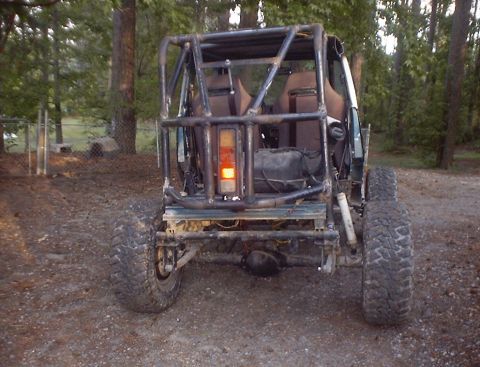 1989 Ford Bronco - Modified 1989 Ford Bronco with custom roll cage and large off-road tires.