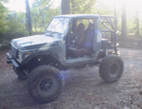 1989 Ford Bronco - This modified Suzuki Samurai is equipped for off-road adventures with its large tires and protective roll cage.