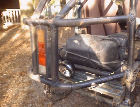 1989 Ford Bronco - This heavily modified off-road vehicle features a custom roll cage and external fuel tank, obscuring its original model year.