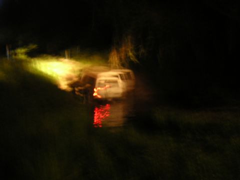 1984 Chevrolet Blazer - A white van is visible at night, its brake lights illuminated on a dark roadside.