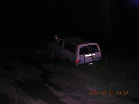 1984 Chevrolet Blazer - A light-colored SUV is parked off-road at night, with a sticker on the rear window.