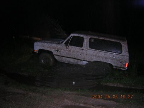 1984 Chevrolet Blazer - This 1984 Chevrolet Blazer is stuck in the mud at night, showing its 4x4 capabilities being tested.