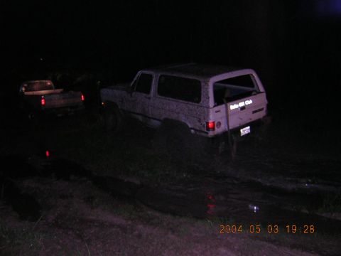 1984 Chevrolet Blazer - Two vehicles are stuck in the mud at night. The main subject is a 1984 Chevrolet Blazer.