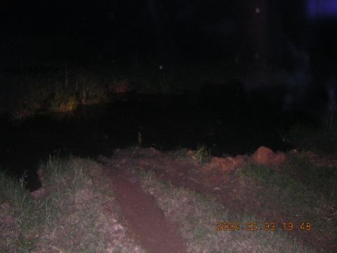 1984 Chevrolet Blazer - A dark scene at night with faint headlights illuminating the background.
