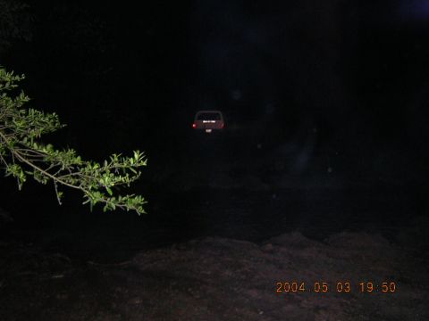 1984 Chevrolet Blazer - A red SUV is seen from the rear at night, with its taillights illuminated.