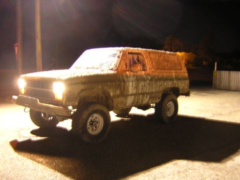 1984 Chevrolet Blazer - 1984 Chevrolet K5 Blazer covered in mud, parked outside at night.