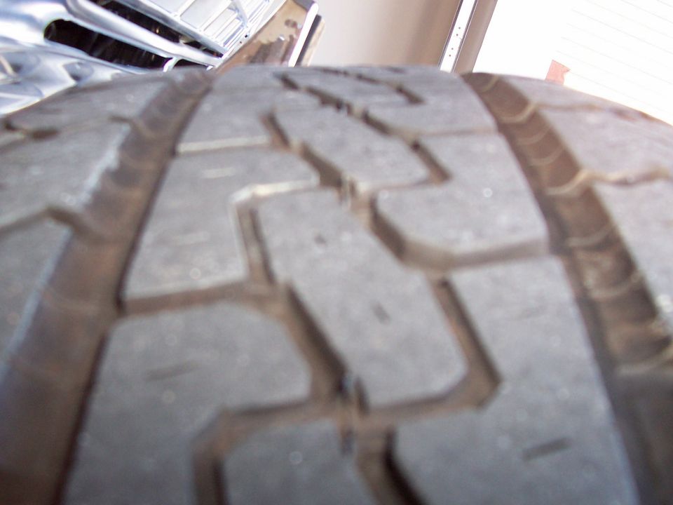 Close-up of tire tread with "SUPERMOTORS www.supermotors.net" watermark