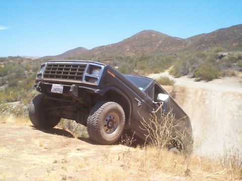 1981 Ford Bronco - Ford Bronco navigating a steep, sandy incline on an off-road trail.