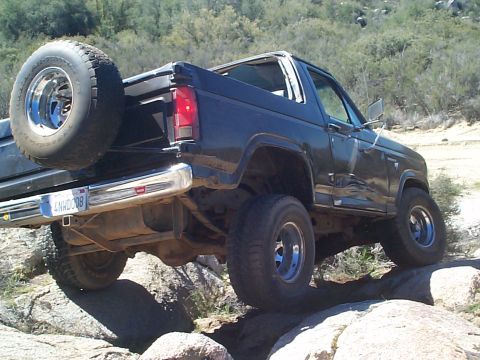 1981 Ford Bronco - Ford Bronco is shown off-roading on a rocky trail.