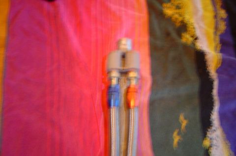 1993 Ford Bronco - Braided fuel lines with fittings, likely for an automotive application.