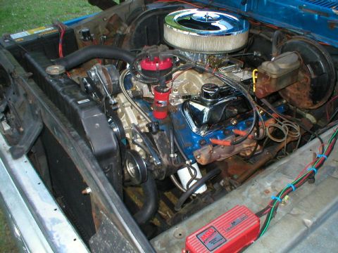 1978 Ford Bronco - Close-up view of a vehicle's engine bay, showing the engine, radiator, and various components.