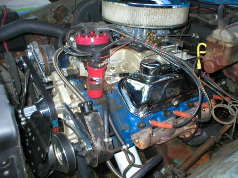 1978 Ford Bronco - Close-up view of a vehicle's engine bay, blue valve covers and a chrome air cleaner assembly.