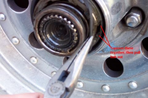 1992 Ford Bronco - Remove the rubber seal, then squeeze the tabs together and pull the hub out