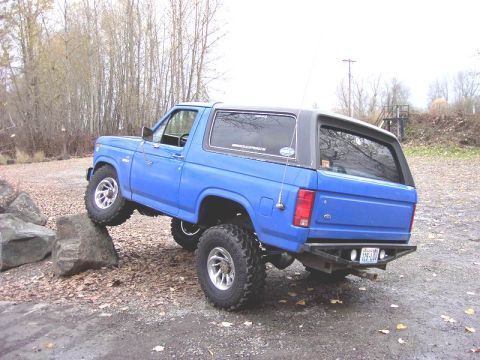 1980 Ford Bronco - This modified Ford Bronco is shown navigating a rocky obstacle course, demonstrating its off-road capabilities.