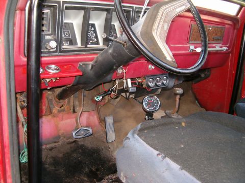 1979 Ford Bronco - Interior view of a 1979 Ford Bronco, the dashboard, steering wheel, and floor pedals.