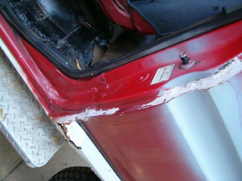 1979 Ford Bronco - This image shows the interior of a vehicle's door jamb, revealing areas of rust and body filler work.