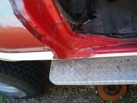 1979 Ford Bronco - Detail of a vehicle's door frame and running board, showing signs of rust and wear.
