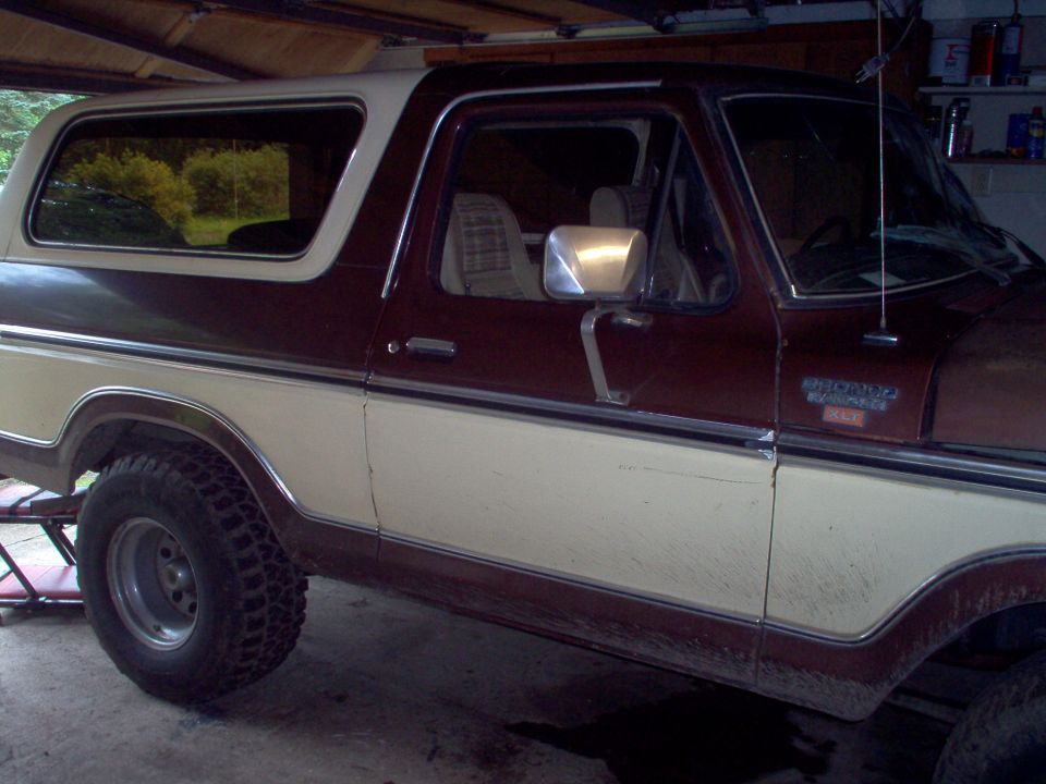 Side view of two-tone brown and cream Ford Bronco SUV in a garage