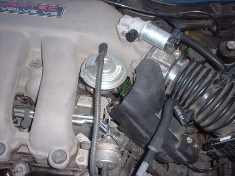1996 Ford Taurus - Engine compartment detail showing various parts of the intake system and emissions control.