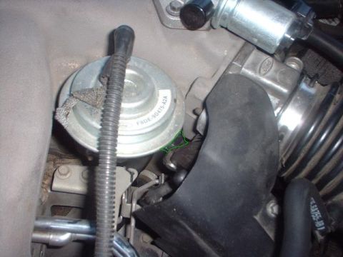 1996 Ford Taurus - This image shows a close-up view of various engine parts, focusing on an intake manifold and associated components.