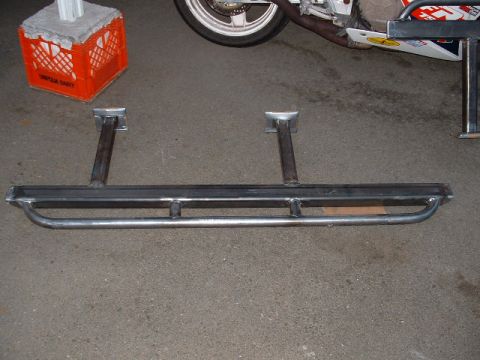 1991 Ford Bronco - Custom slider bars are shown on a concrete surface, with a motorcycle wheel visible in the background.