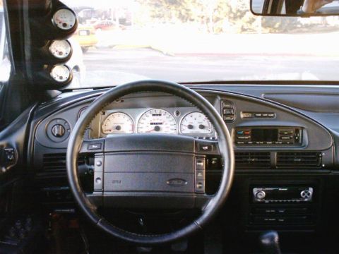 1998 Ford Taurus - Interior view of a 1998 Ford Taurus, aftermarket gauges mounted on the A-pillar and the original dashboard layout.