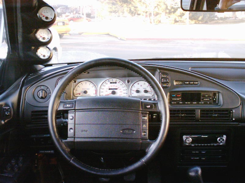 1998 Ford Taurus interior with aftermarket gauges and stock dashboard