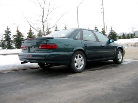 1998 Ford Taurus - Rear view of a 1998 Ford Taurus sedan in dark green.