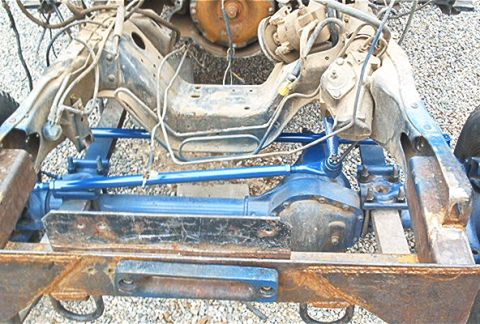 1986 Ford Bronco - Close-up view of a vehicle's front suspension and chassis components, showing a mix of painted and rusted metal.