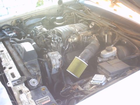 1991 Ford LTD Crown Victoria - The engine bay shows a V8 engine with an aftermarket air filter installed.